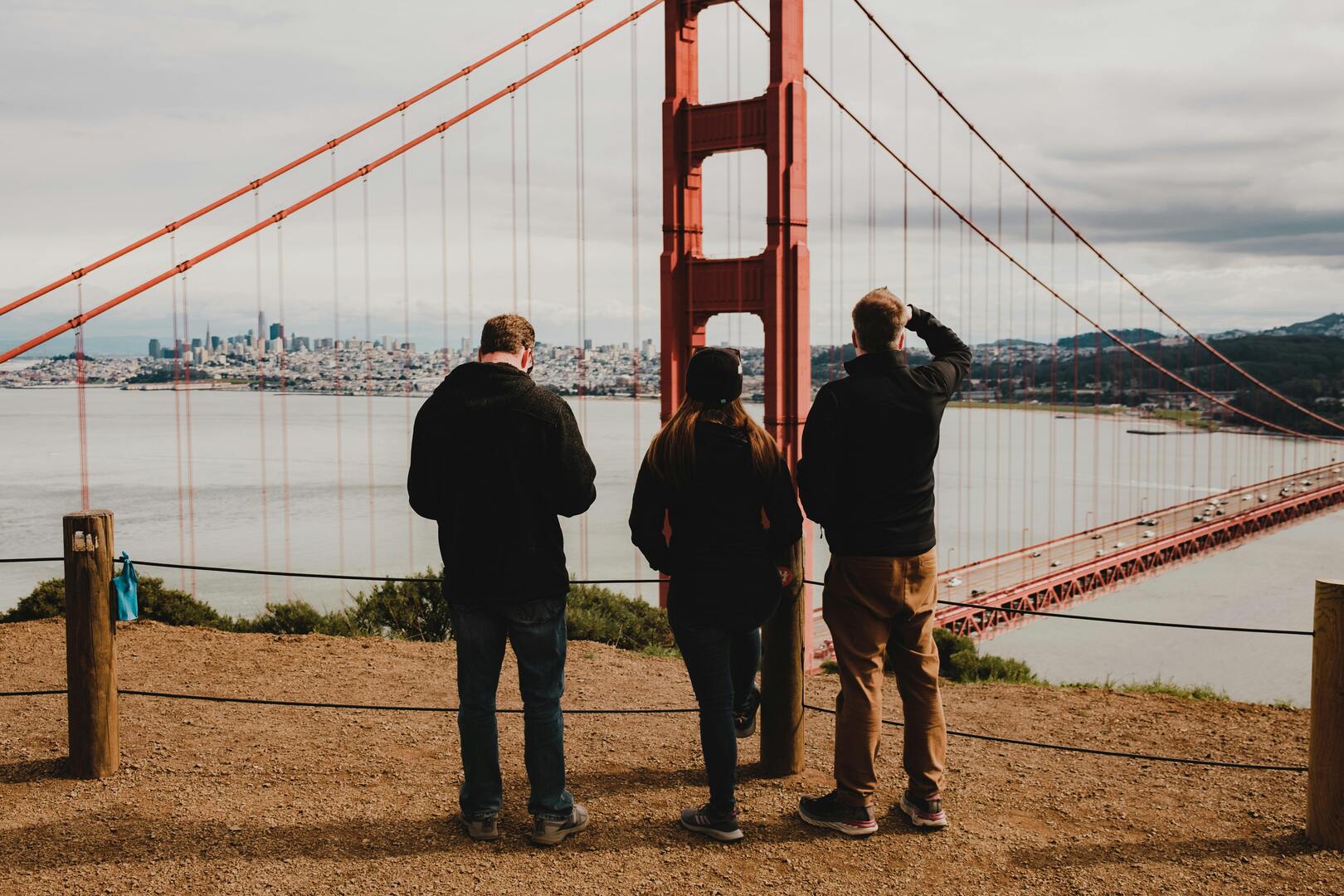 Cyclists at Golden Gate Bridge viewpoints with panoramic bay photography